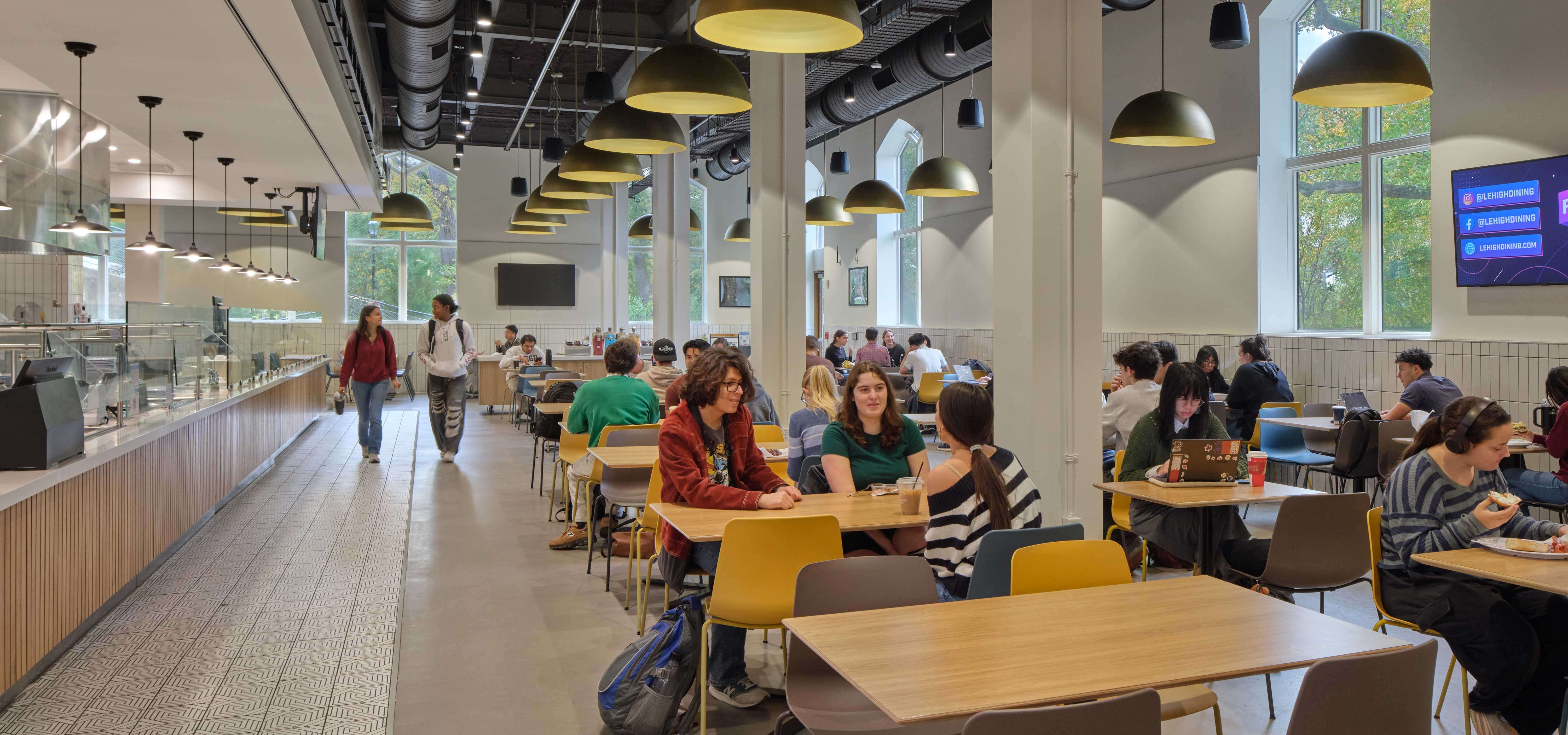 Students occupy the Lower Eatery in clusters of friends.