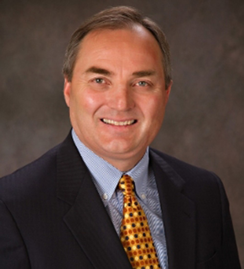 Lyle Hogg in a blue shirt and sport coat and yellow tie.