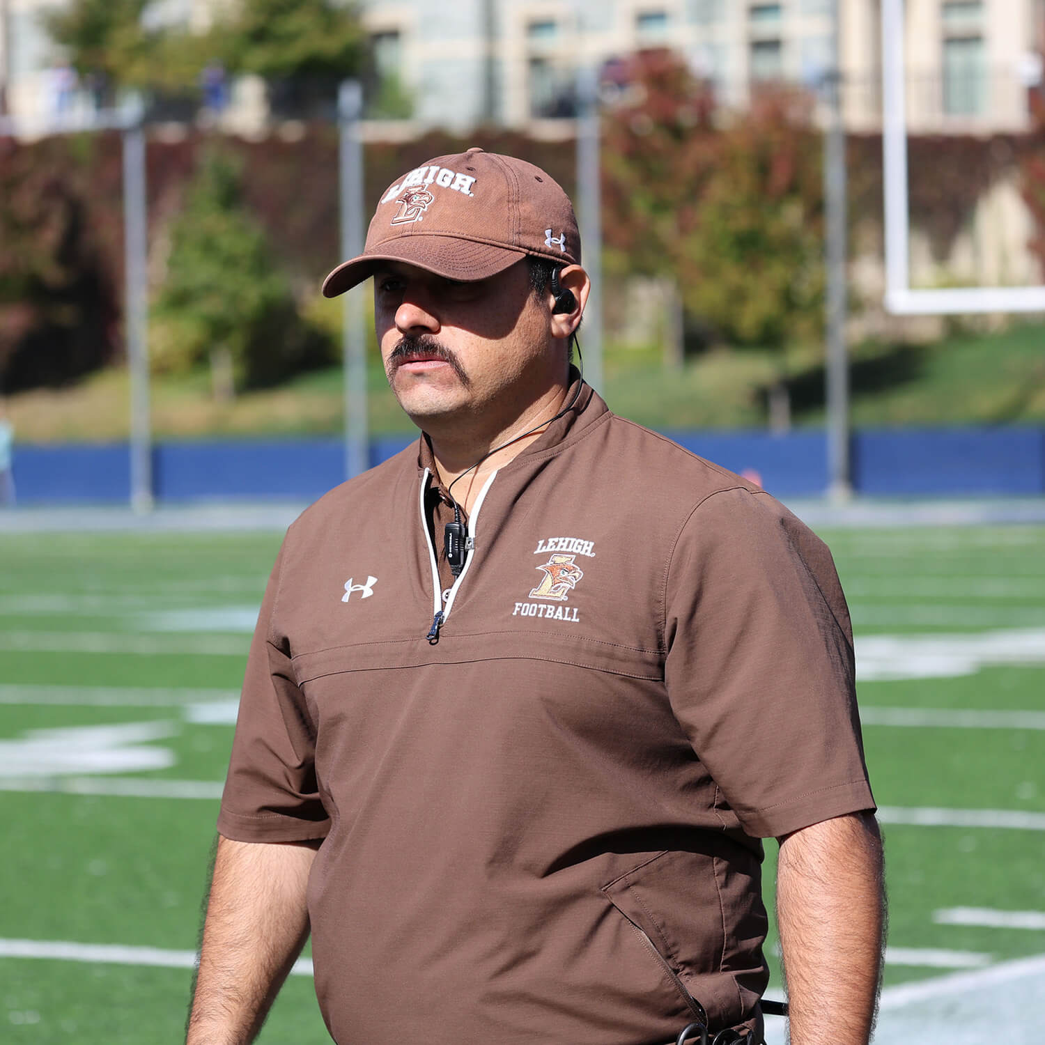 Marco Giuliani, the assistant athletic director for sports medicine, stands on the sideline during a Lehigh football game