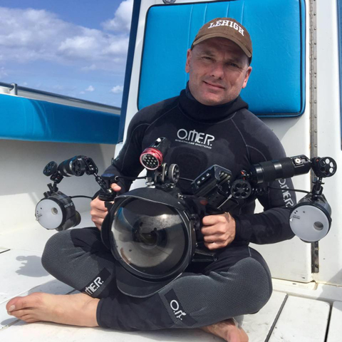 Michael Patrick O'Neill in a dive suit with camera, wearing a Lehigh hat
