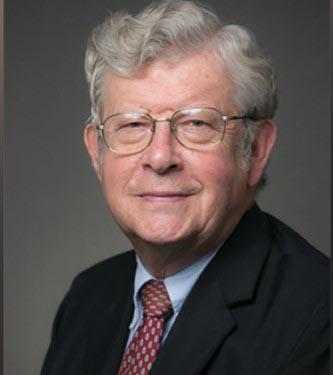 Ned Heindel in a black suit with a blue shirt and maroon tie.