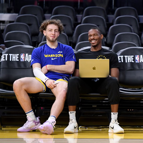 Noel Hightower sits in the stands with Golden State Warrior basketball star Brandin Podziemski