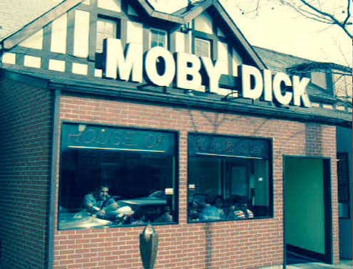 An image of the original Moby Dick location back in 1989. 'House of Kabob' is displayed on the windows, and people sit inside.
