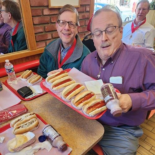 A Lehigh alum shows off his tray of greekers - a hotdog with a steamed bun, mustard, onions, and a secret sauce.