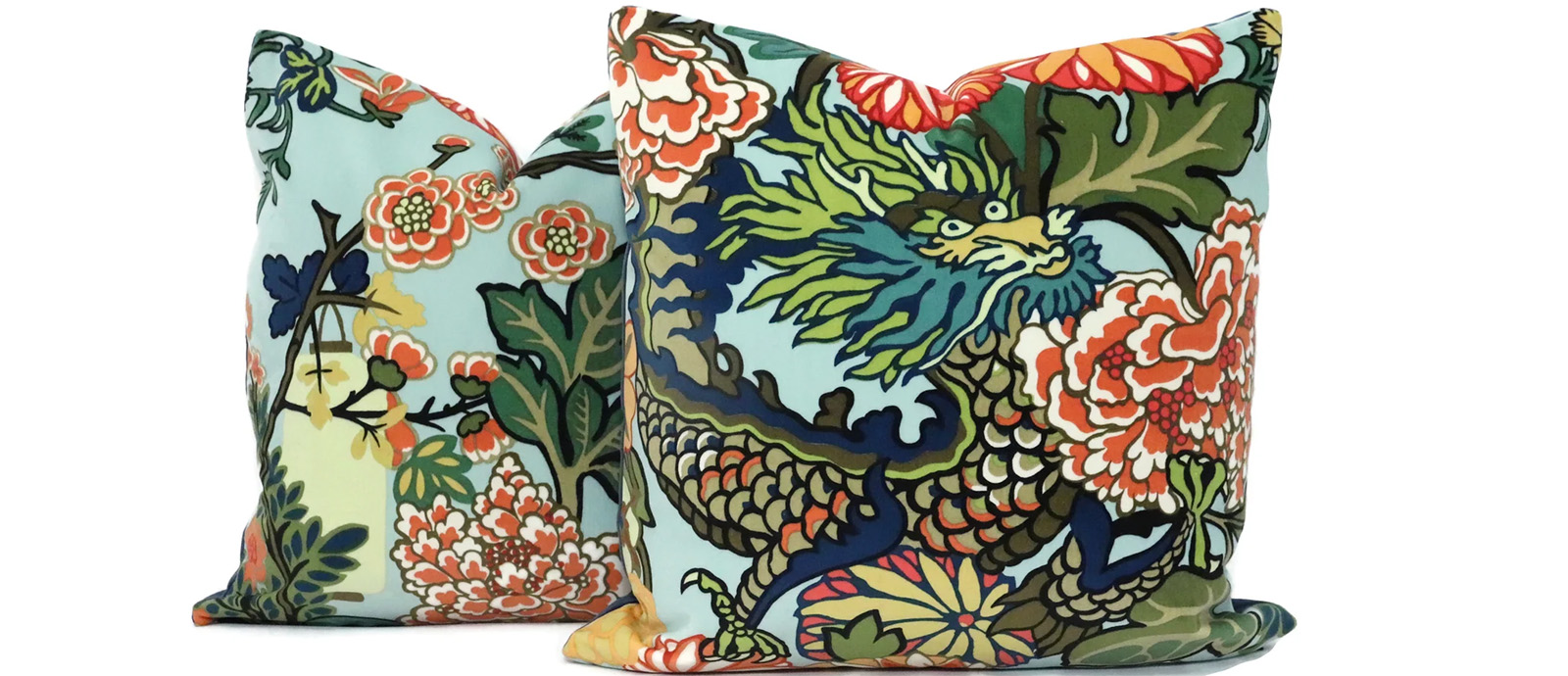 Two colorful pillows with an asian floral and dragon theme print