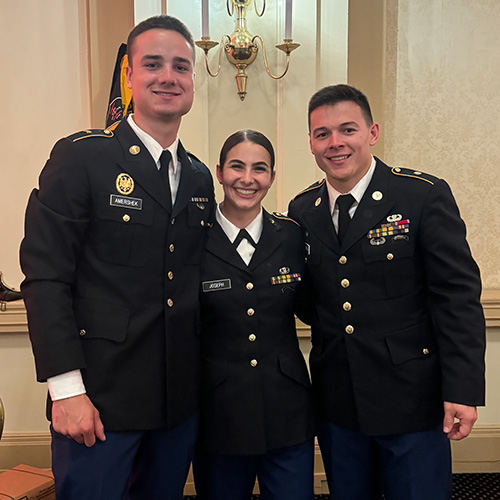 Ethan, Sacha, and Angelo stand together in their dress blues.