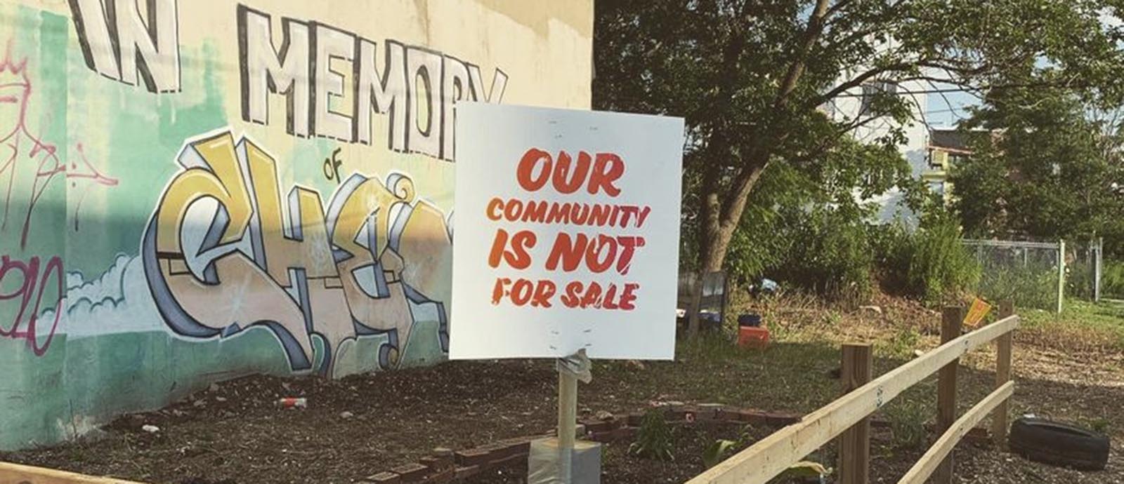 A sign at an urban garden reminds viewers who owns the community