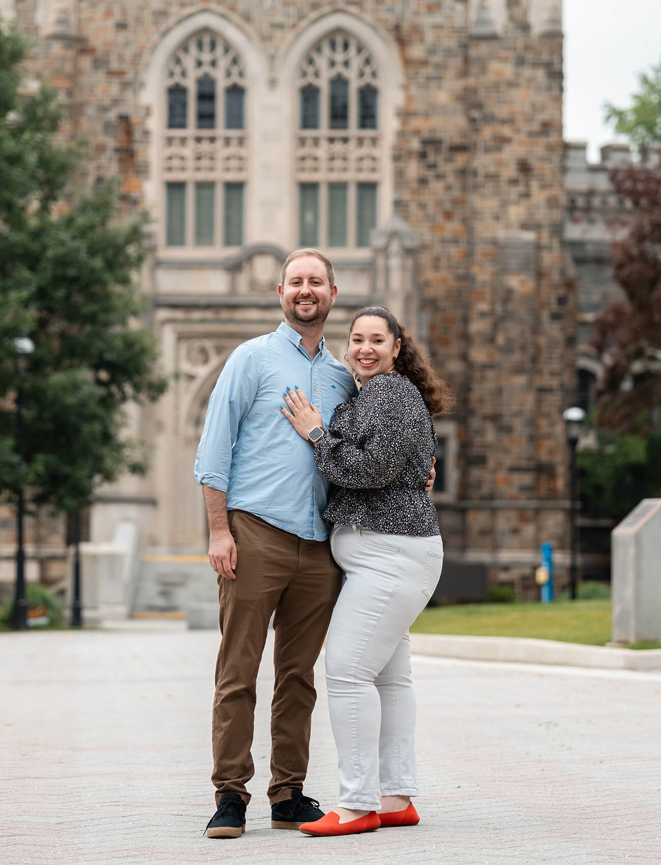 Sara Anderson poses on campus alongside Christian Hillegas with her hand on his chest.