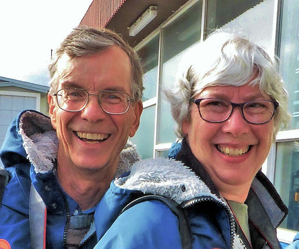 Ron and Gail smile while wearing heavy blue parkas