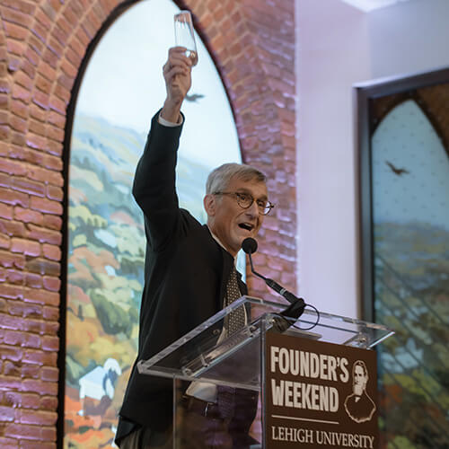 President Joseph Helble raises a glass to toast the newly dedicated Clayton University Center
