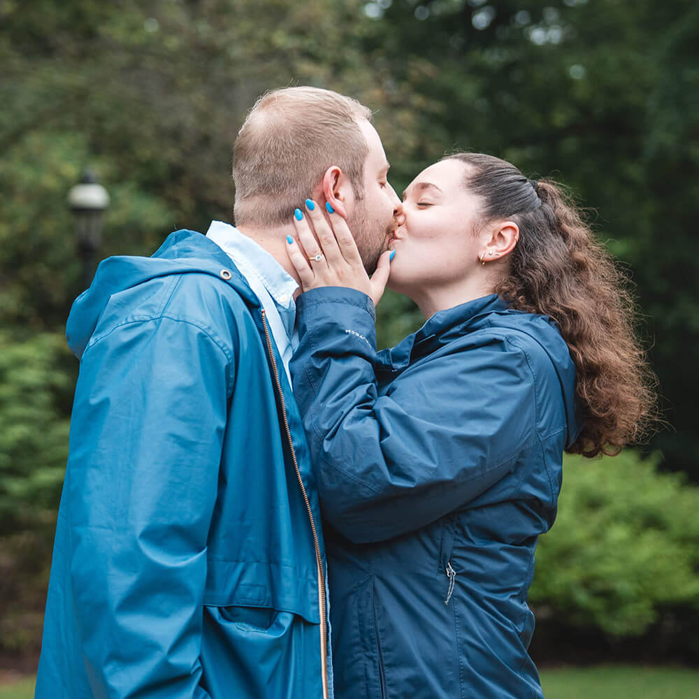 Anderson kisses Hillegas after their proposal at Reunion, holding his face with both hands.