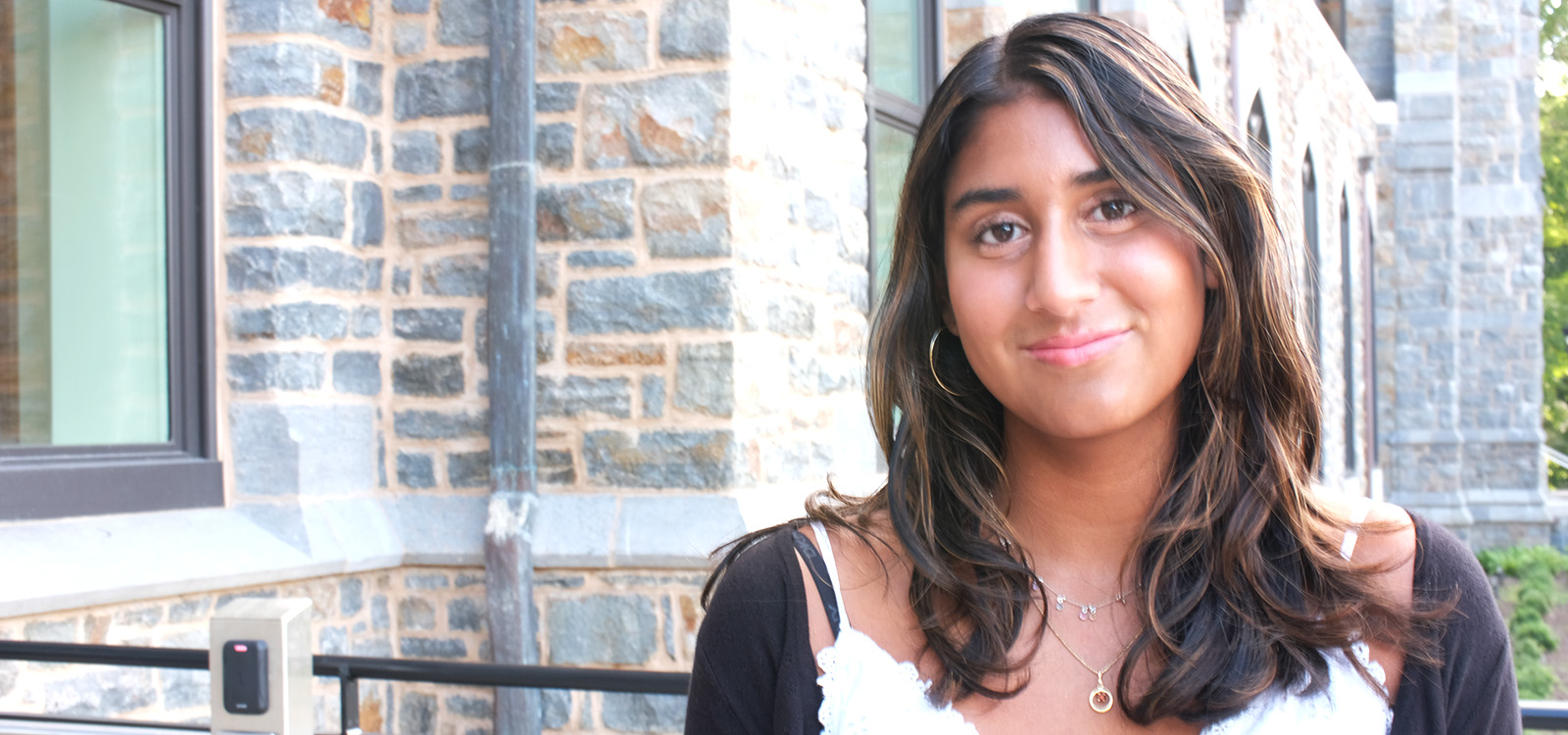 Dhyana Abeysinghe stands on the steps of the Clayton University Center