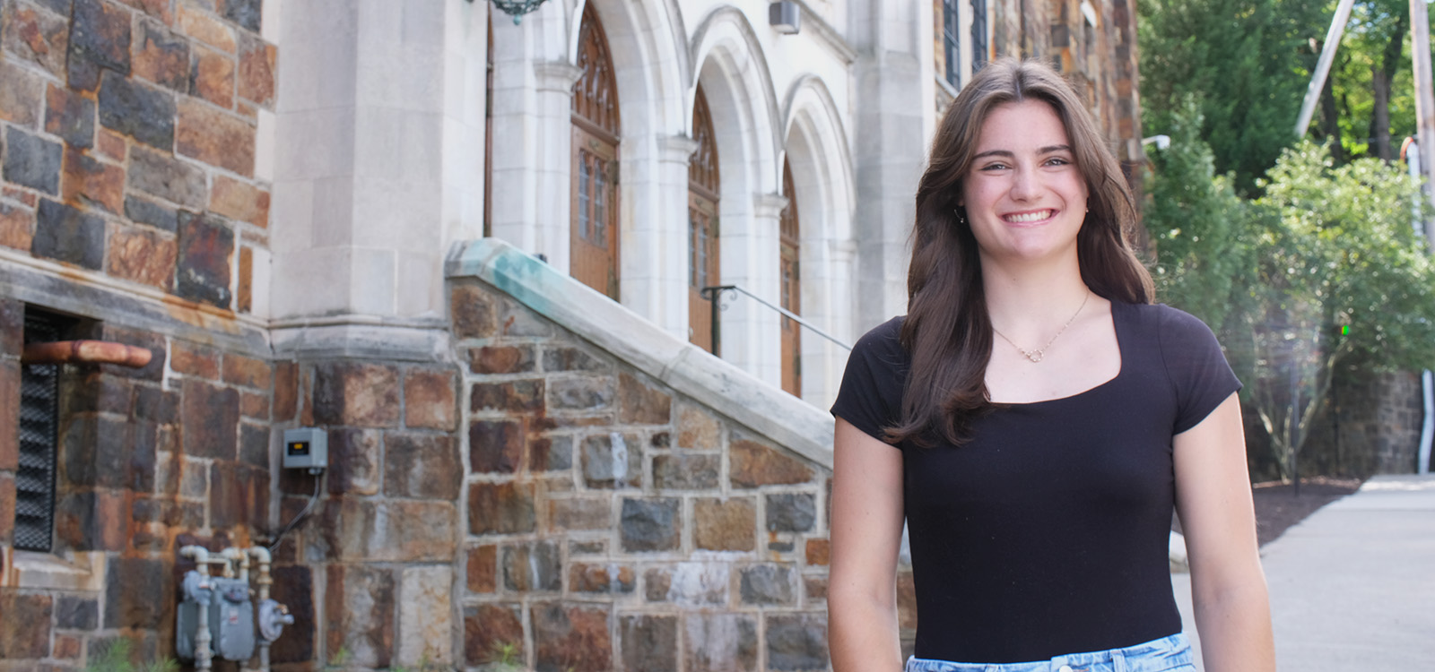 Paige De Caro stands outside Grace Hall