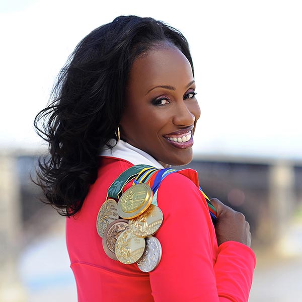 Jackie Joyner-Kersee holds her Olympic medals over her shoulder