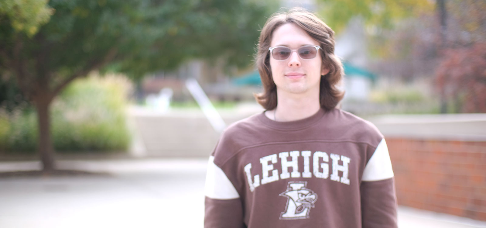 Sean Henry stands in the FML plaza in a Lehigh shirt