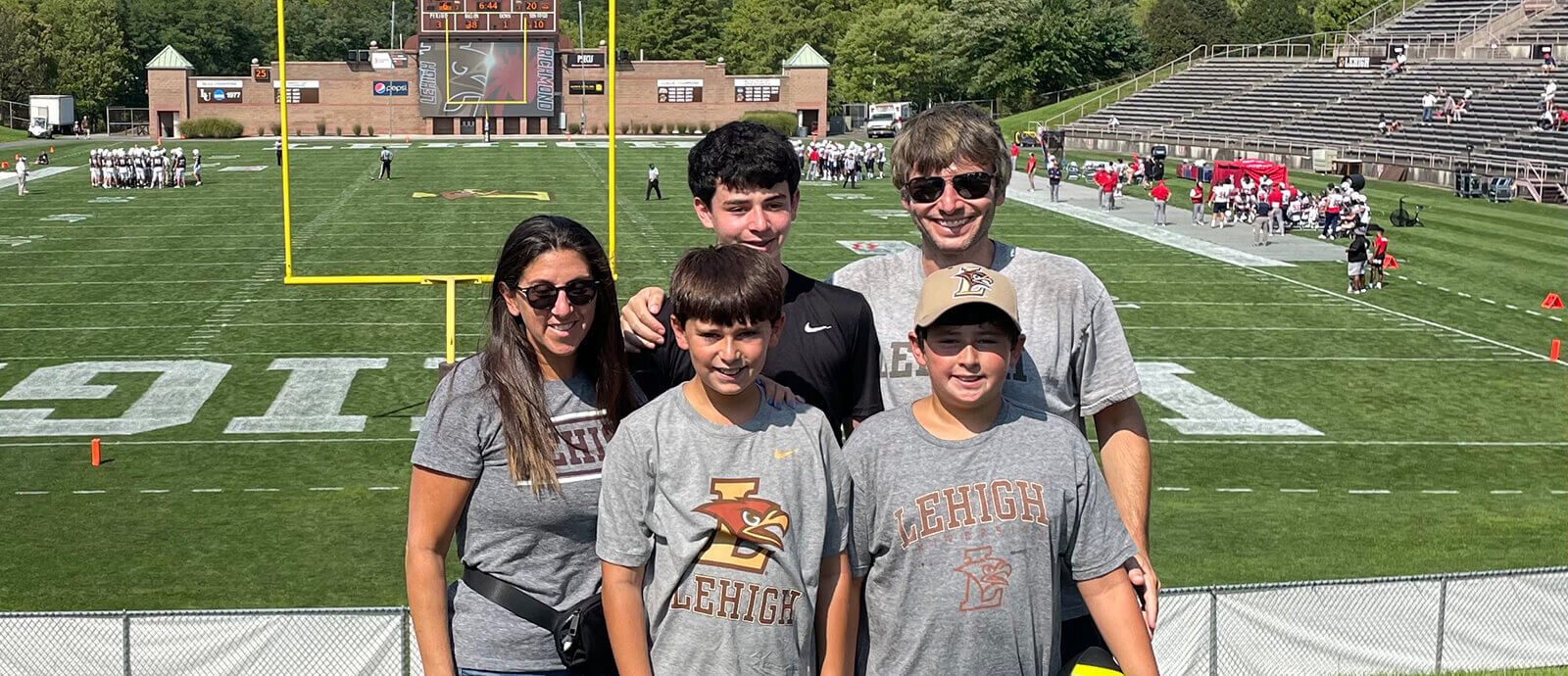 The five members of the Shmelzer family smiling in Goodman Stadium.