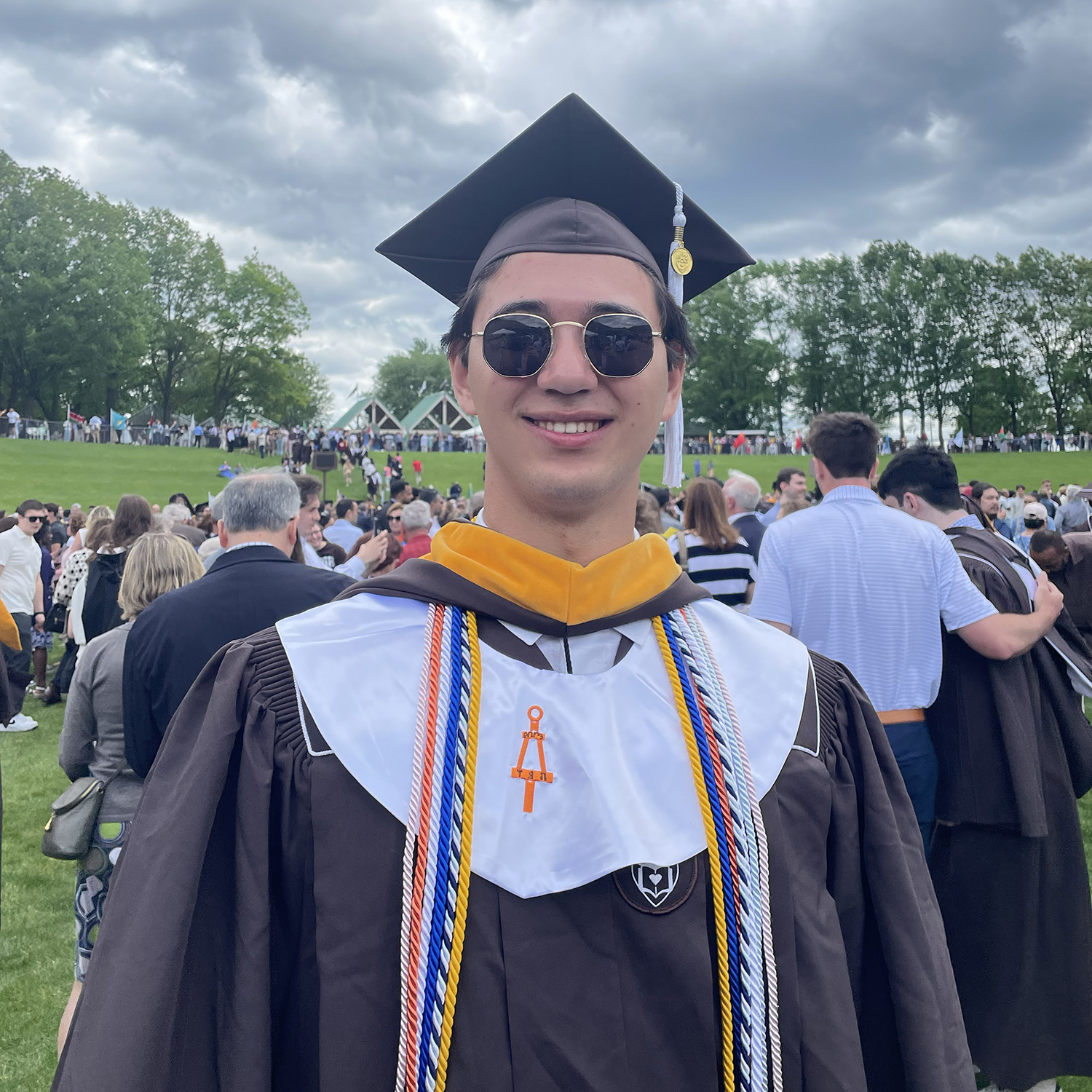 Skyler smiles in his Lehigh graduation cap, gown, and cords. 