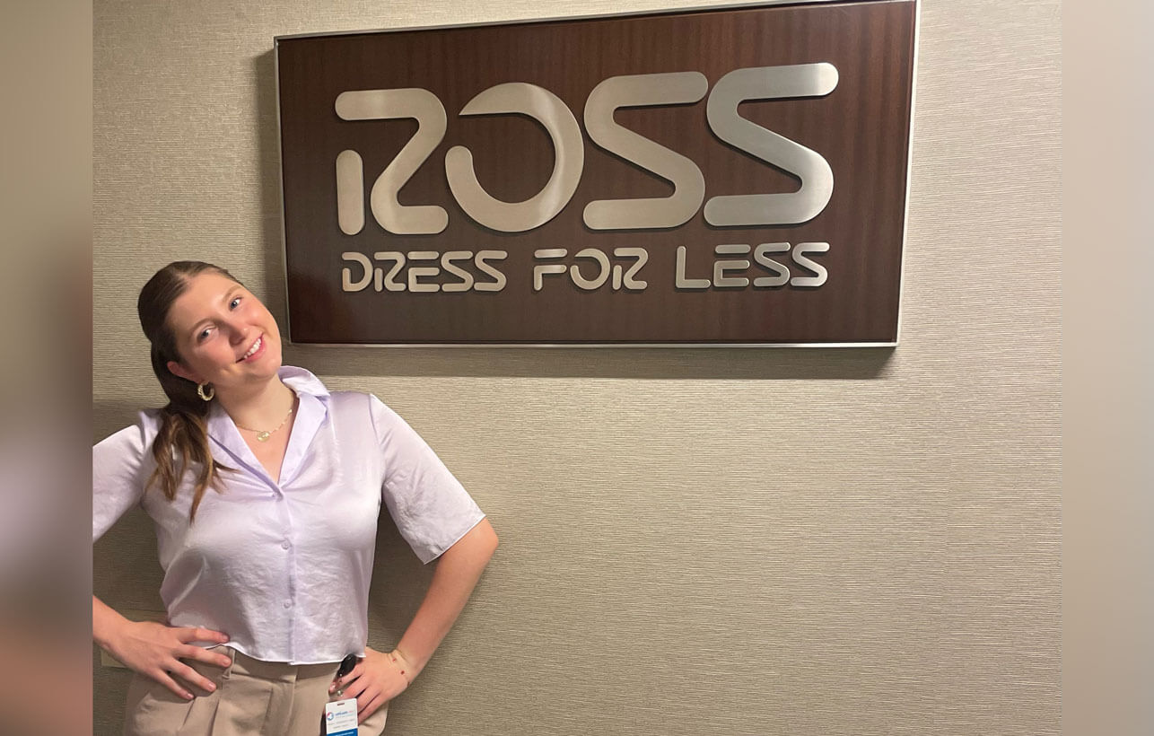 Sophia Luttrell standing next to the Ross, dress for less, logo