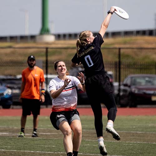 Madison Cannon leaps to catch a disc 