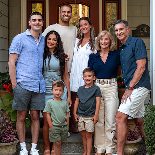 The full Vandergrift family stands on a front porch
