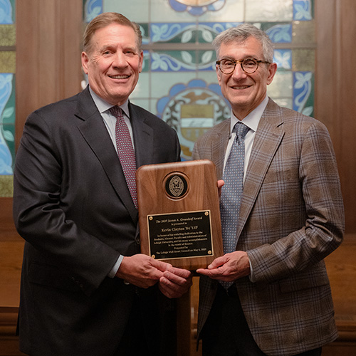 Kevin Clayton accepts award from President Joe Helble