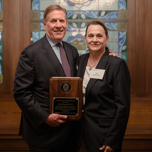 Kevin and Lisa Clayton hold his award