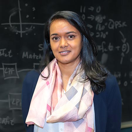 Shawnee Kishore in front of a blackboard