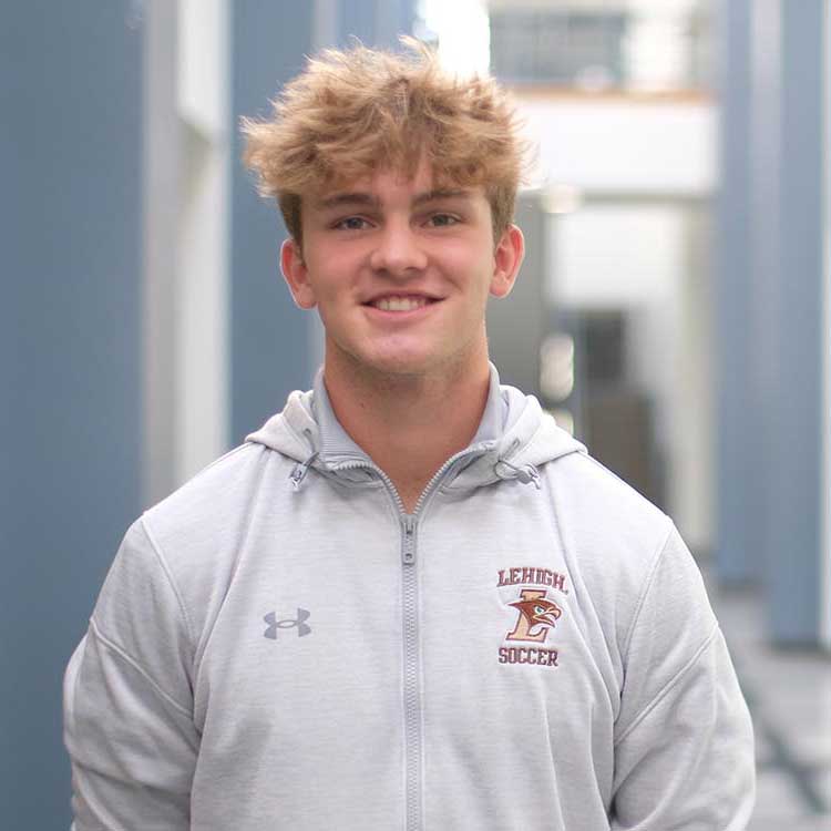 Calan Armitage smiles and wears a Lehigh Soccer hoodie.
