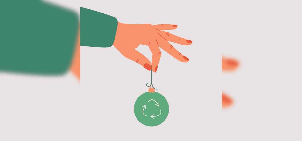 A vector illustration of a hand holding a green ornament with the recycling symbol on a string.
