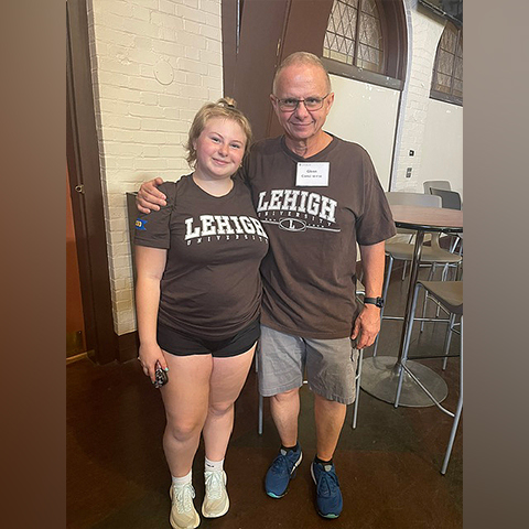 Gillian and Glenn stand side-by-side in brown Lehigh shirts. A blue 2030 patch is visible on Gillian's arm.