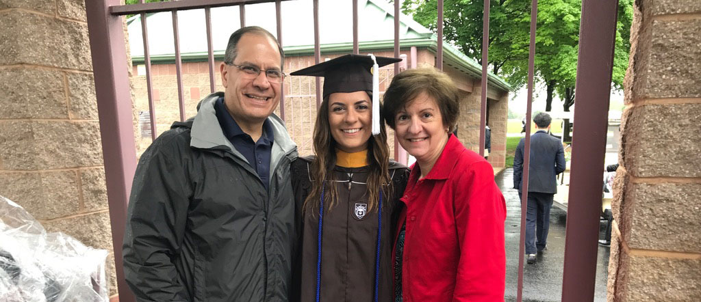 Fotinos Panagakos ’86, ’07G stands with his spouse Judith Lannin Panagakos '86 with their daughter Alexandra '17 at her graduation