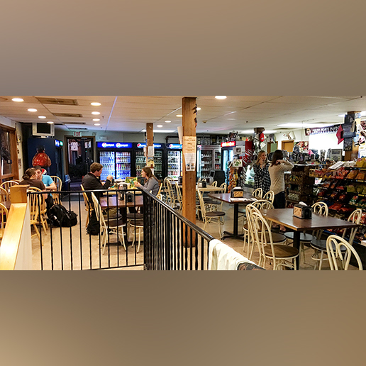 Interior shot of The Goose with students sitting at tables and standing in line to order.