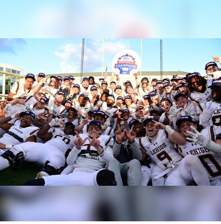 Lehigh football players in white uniforms poise for a group photo and hold a "Patriot League Champions" sign