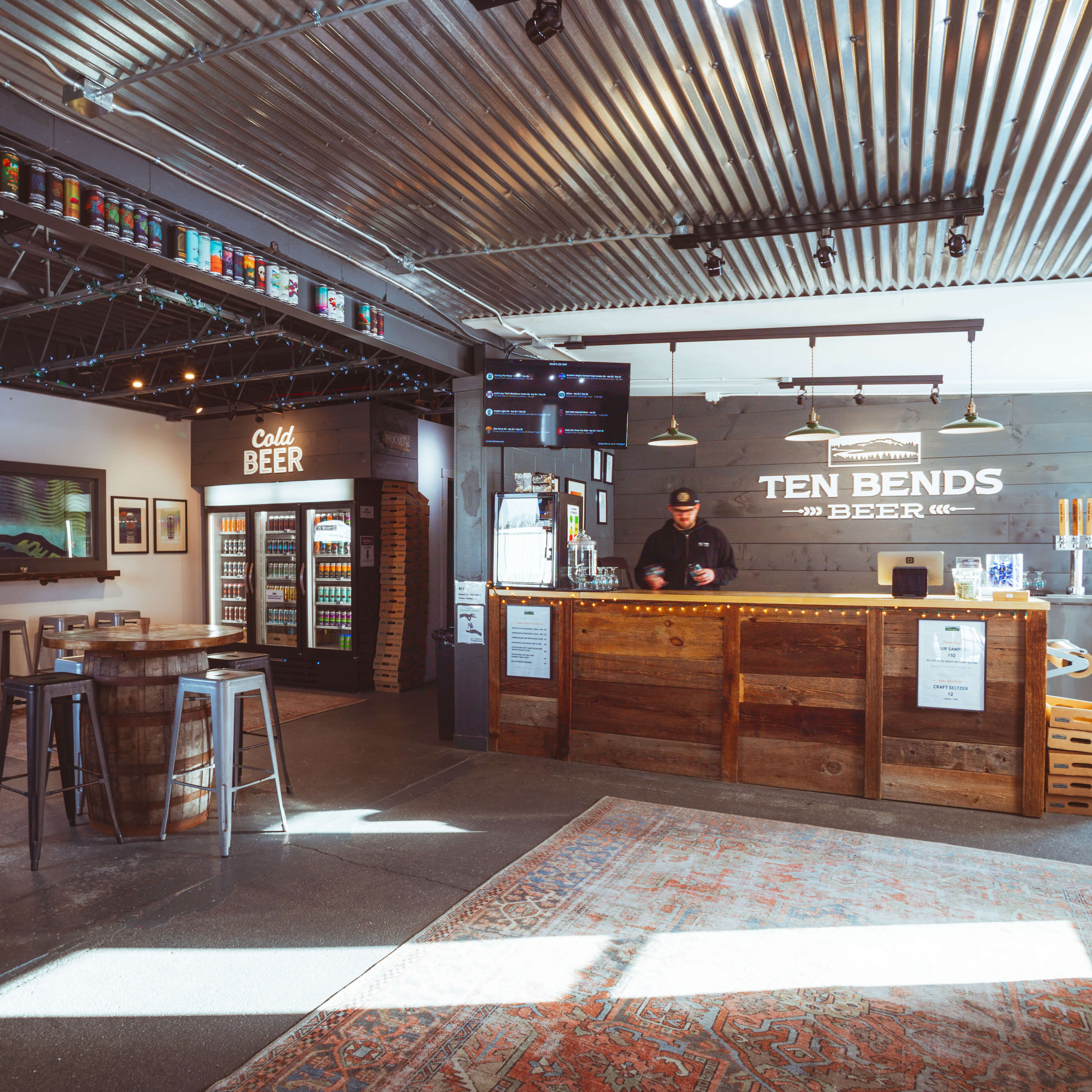 The interior of a tap room featuring rustic and industrial decor
