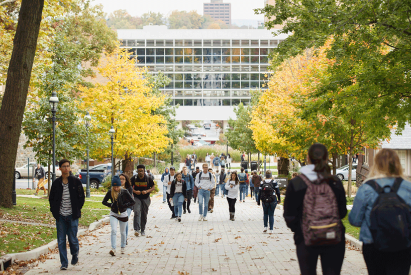 A crowd of students walking outside between classes on Lehigh University's campus.