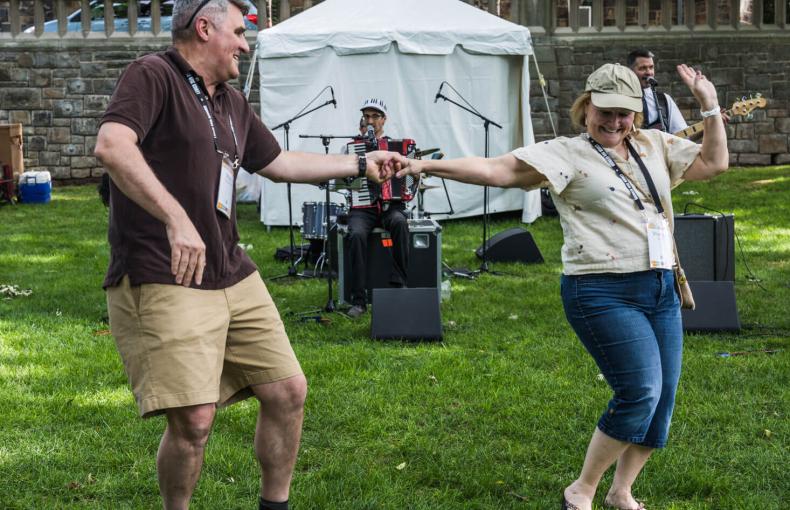 An older man and woman dancing to live music on the lawn at Lehigh Univeristy