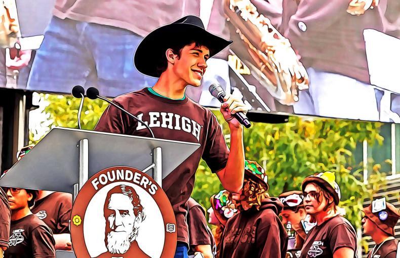 Student wearing a Lehigh t-shirt and wearing a cowboy hat while speaking into a microphone