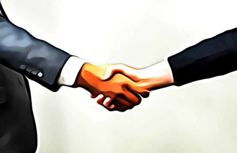 Two hands coming together in a handshake