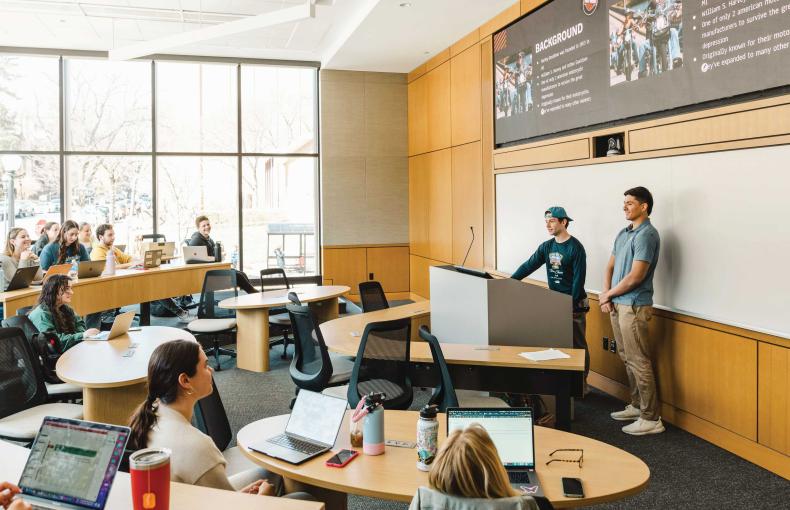 Two students presenting to a classroom of students.