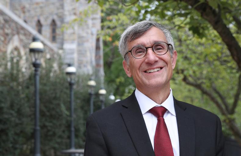 President Helble smiles while standing outside.