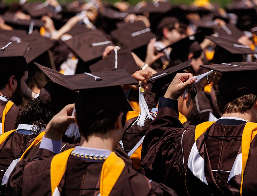 Lehigh students in their caps and gowns move their tassels