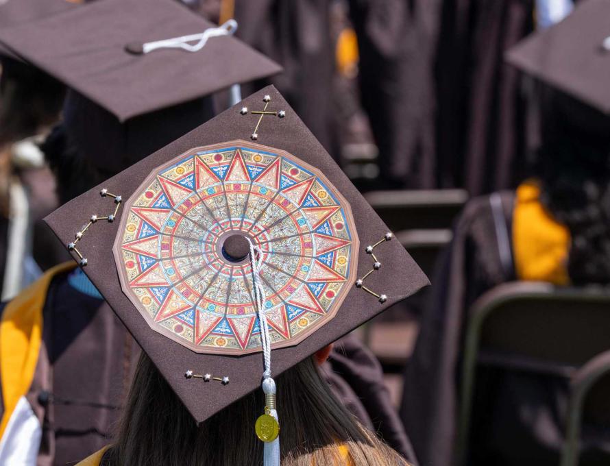 A brown graduation cap with a large image showing the Linderman Rotunda.