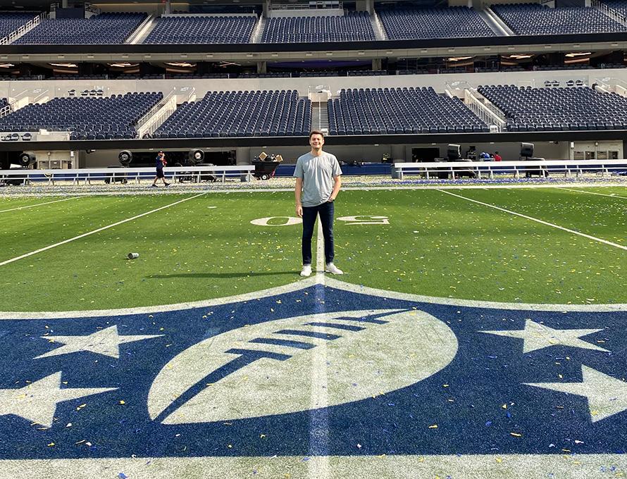 Ollie Auerbach stands at the midfield of Super Bowl LVI
