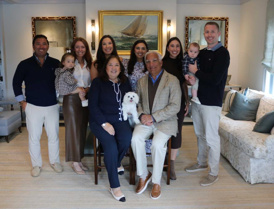 The Maida family gather in their living room for a posed photo. 
