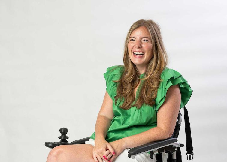 Brooke Eby wearing a large smile and a bright green shirt with ruffles.