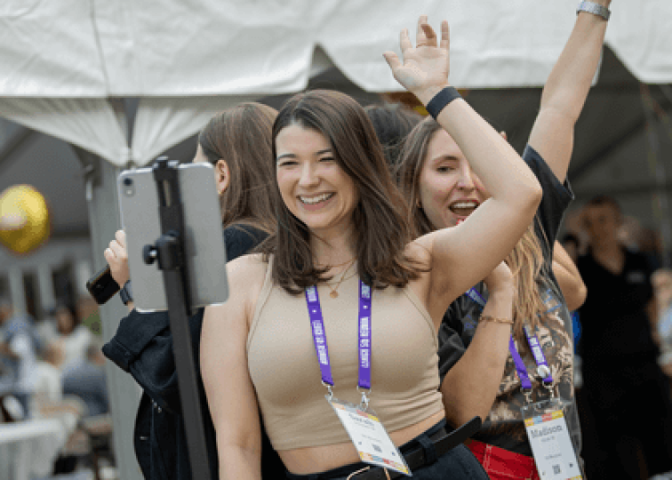 A small group of women dancing and posing for a 360 degree camera at a outdoor Reunion event.