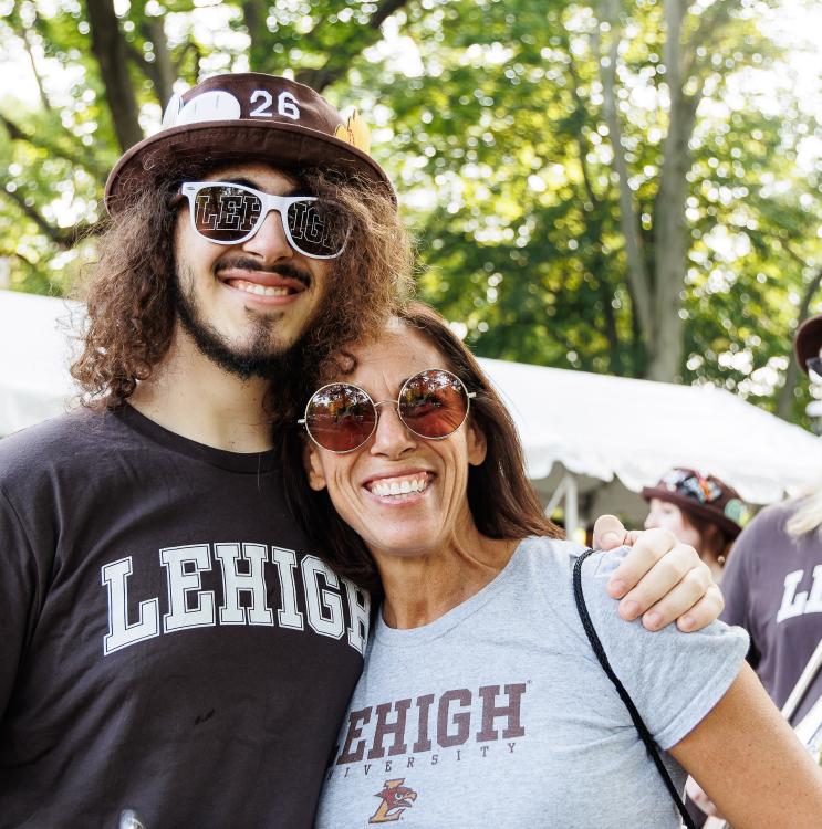 A student and their parent wearing Lehigh gear at the Brown and White BBQ