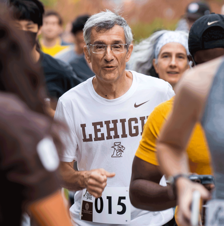 President Helble running on campus during Founder's Weekend