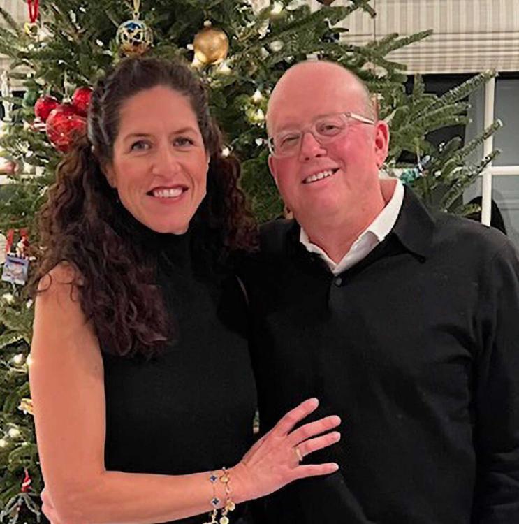 Dan and Mariela Pietrzak standing together in front of a Christmas Tree.