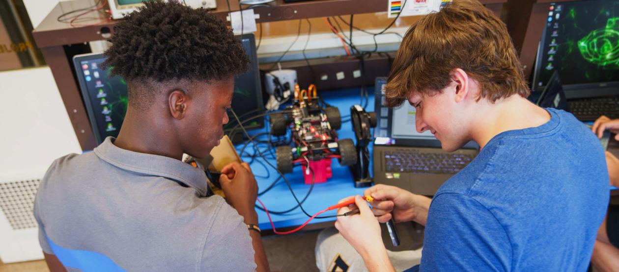 Two students working on a robotics project together